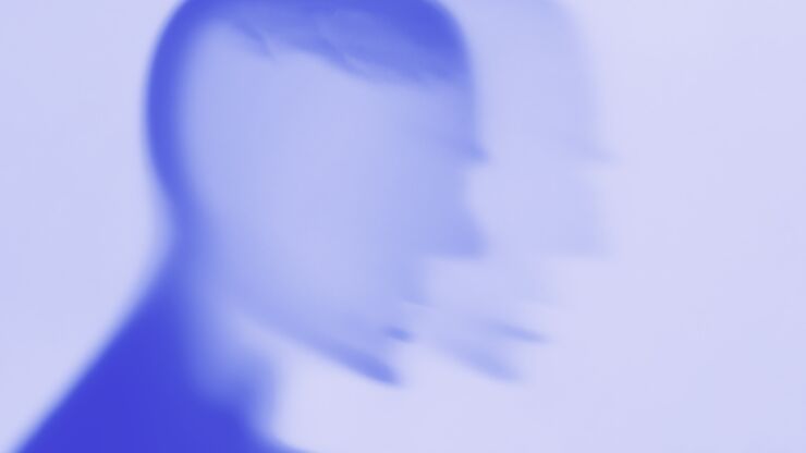 Blurry illustration, silhouette of a head in blue monochrome tones.