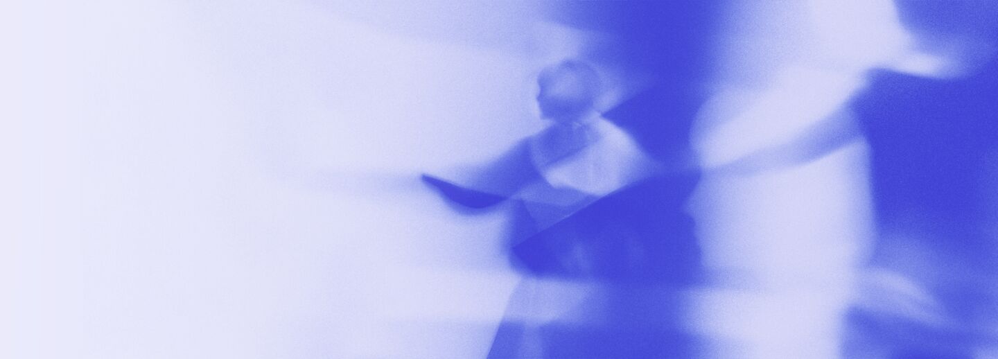 Abstract and blurry image of people in motion, monochromatic in purple tones.